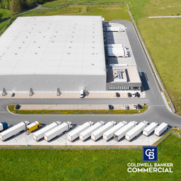 Industrial Warehouse Aerial View - Loading bay, truck parking lot, industrial building, logistics - aerial view